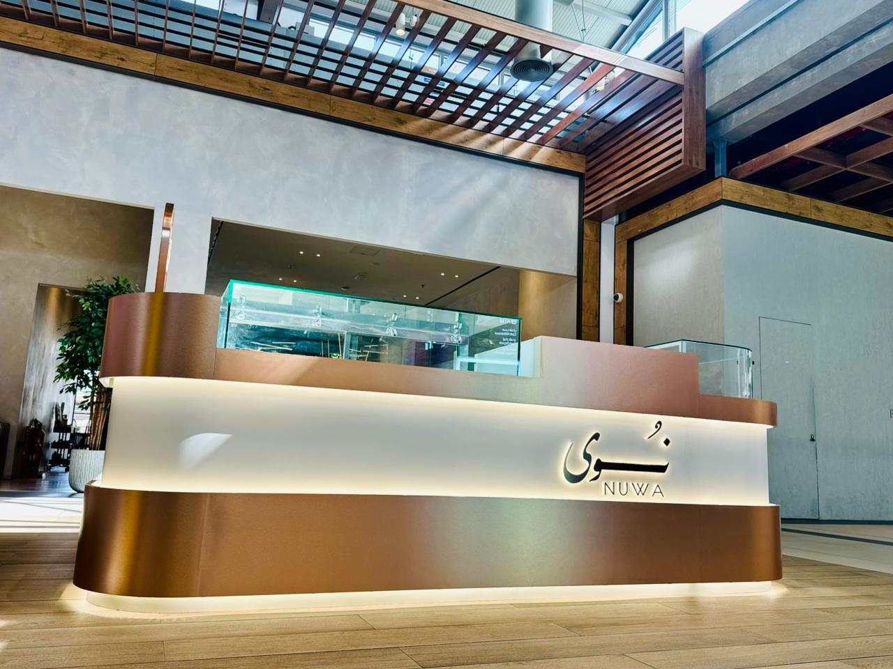 Completed retail kiosk interior fit-out with illuminated bronze counter