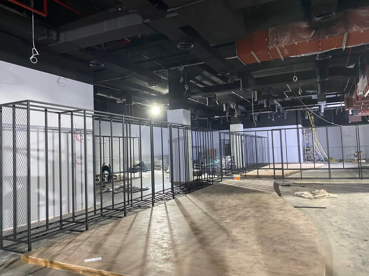 Close-up of MEP cabling and ductwork installed above a suspended ceiling