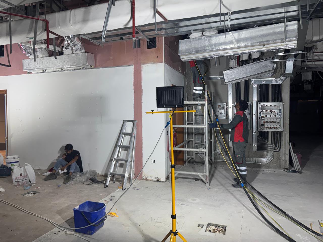 Electrician working on a commercial electrical distribution panel