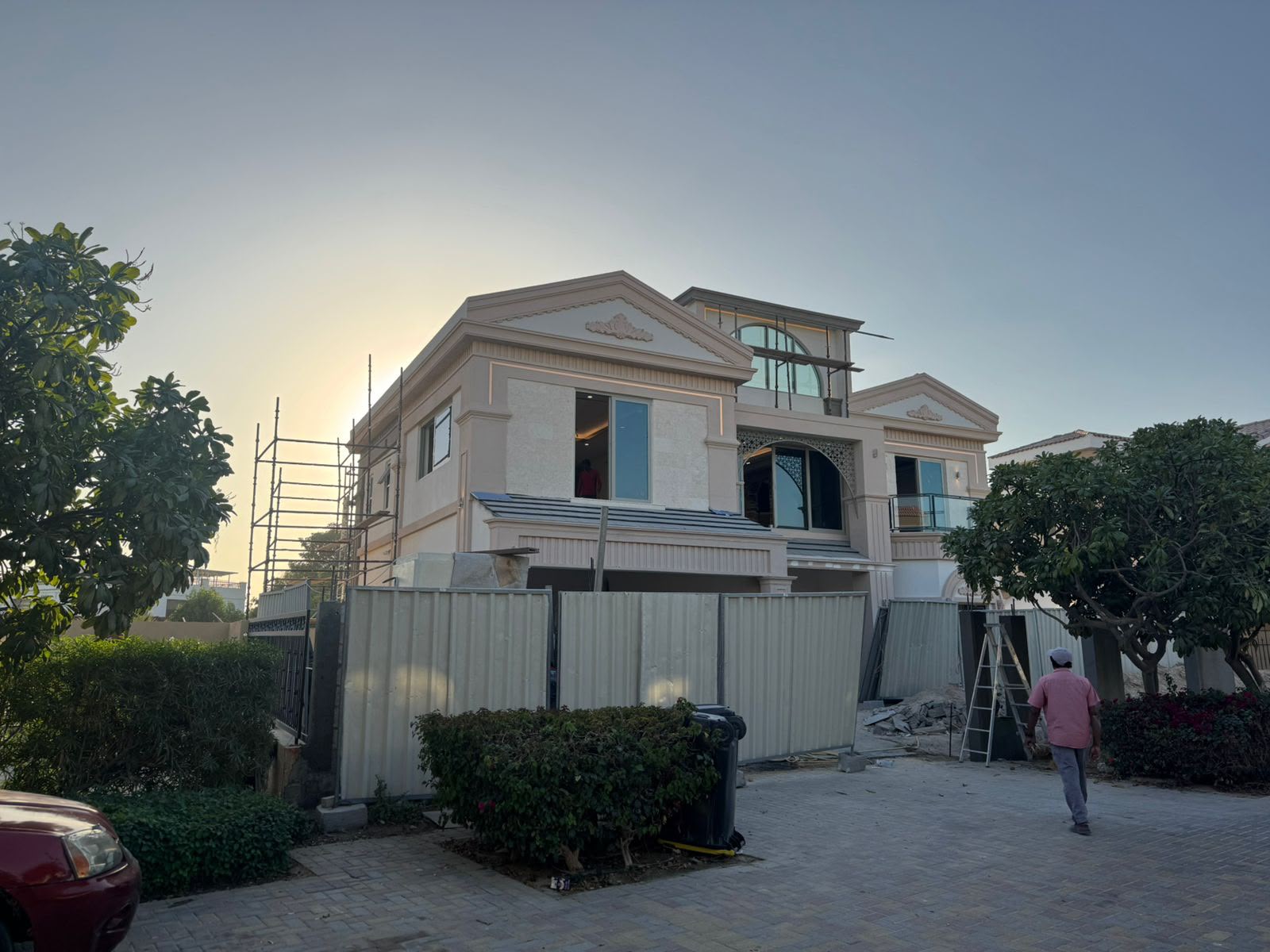 Completed villa exterior with classical architectural detailing at dusk