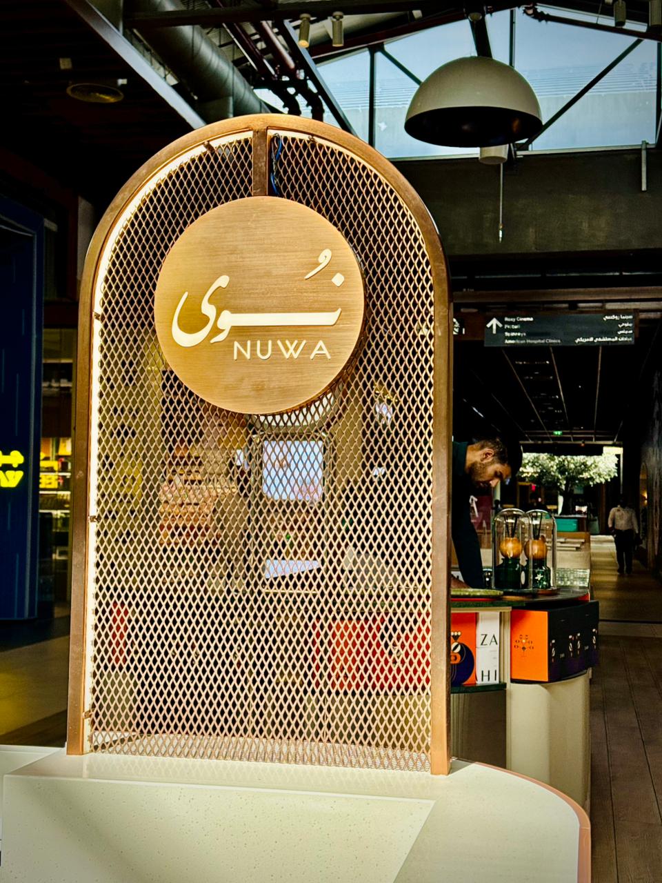 Completed kiosk signage with staff member serving a customer